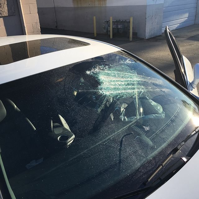 Technician replacing a cracked windshield with OEM-grade glass